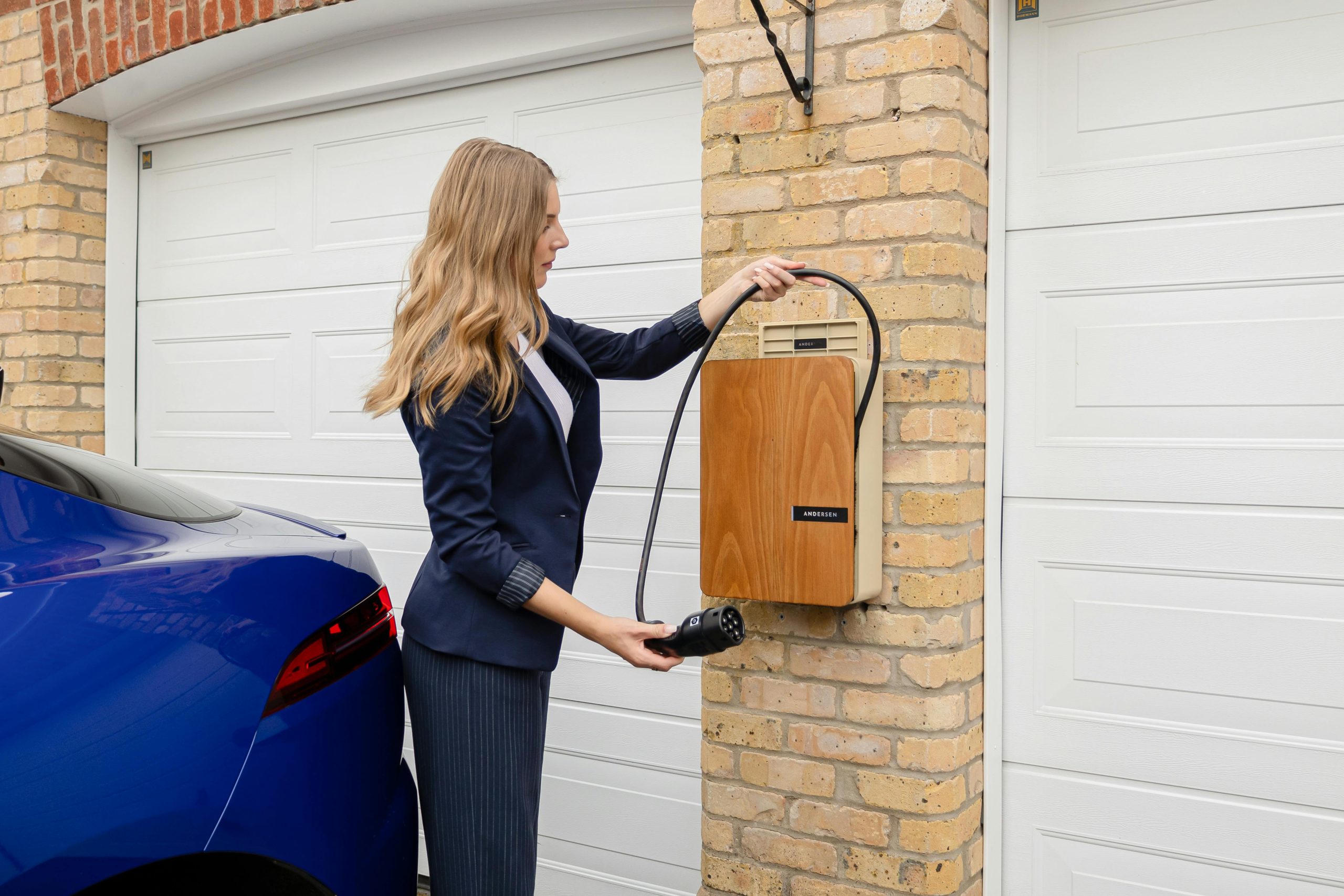 pexels-andersen-ev-1587213396-27355827 EV charging set up lady getting redy to use a home wall mounted ev charger