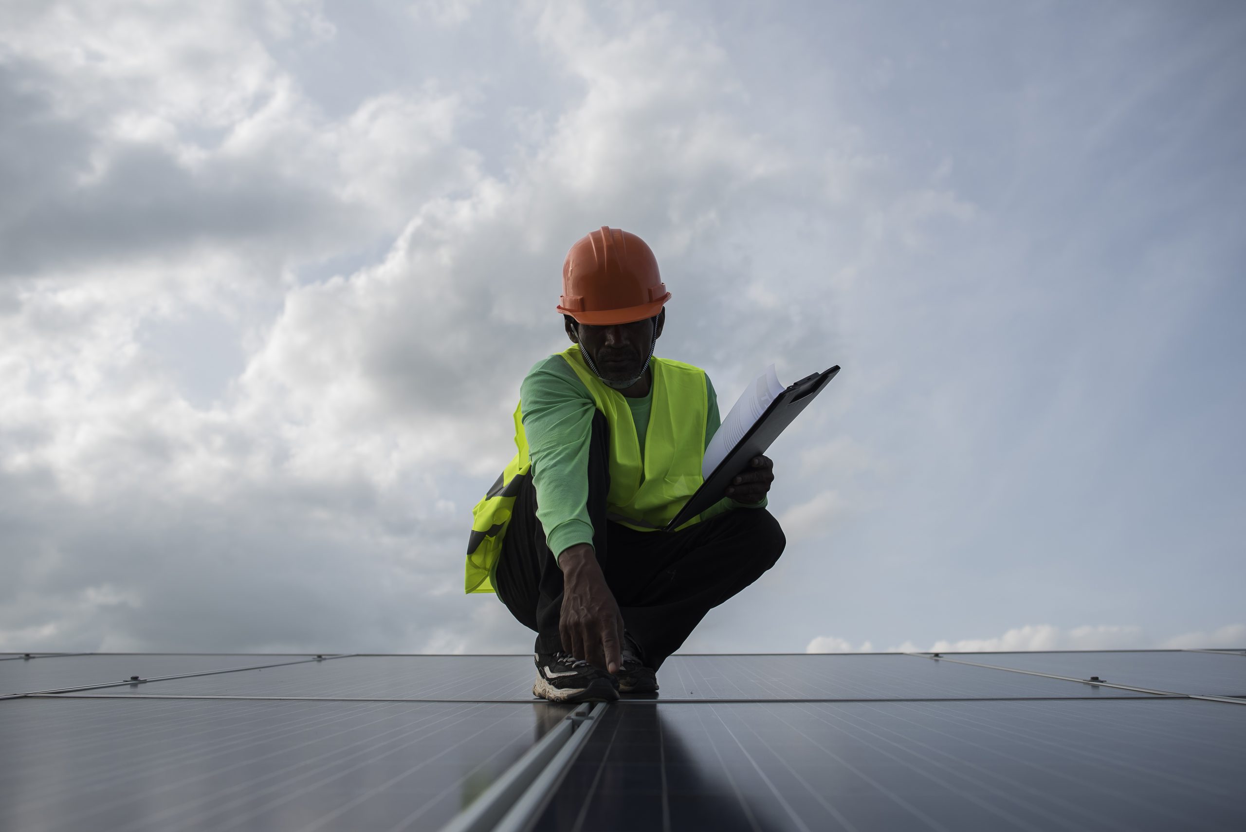 Technician engineer checks the maintenance of the solar cell pan Man inspecting and reporting solar panels solar panel maintenance in Guildford Surrey Solar Solutions