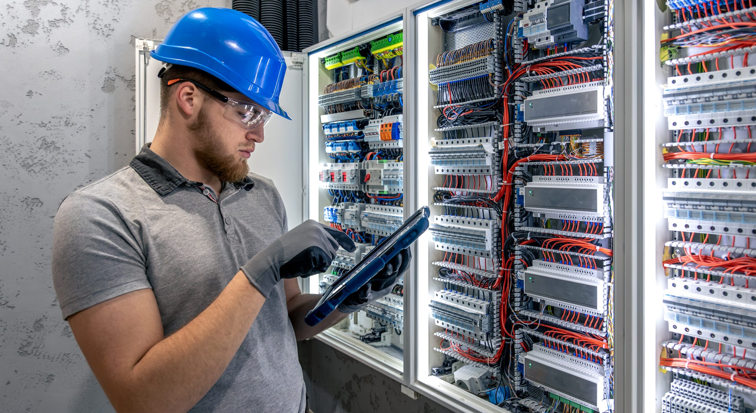 Solar panel maintenance in Hook Storage battery inspections Man inspecting storage batteries